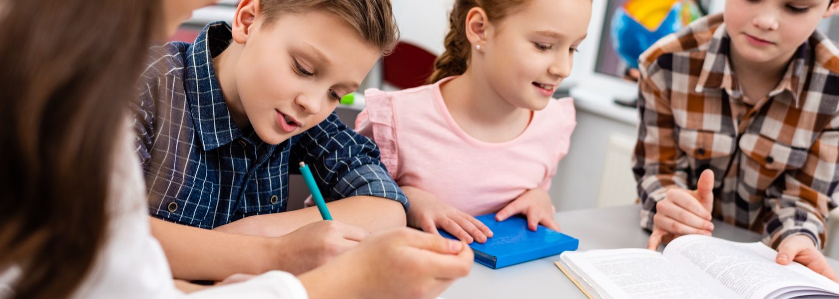 Students writing together at a classroom table
