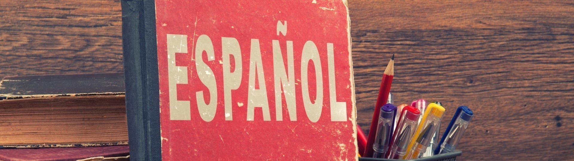 Red Espanol book standing beside a cup of colored pencils, ready for a classical Spanish curriculum
