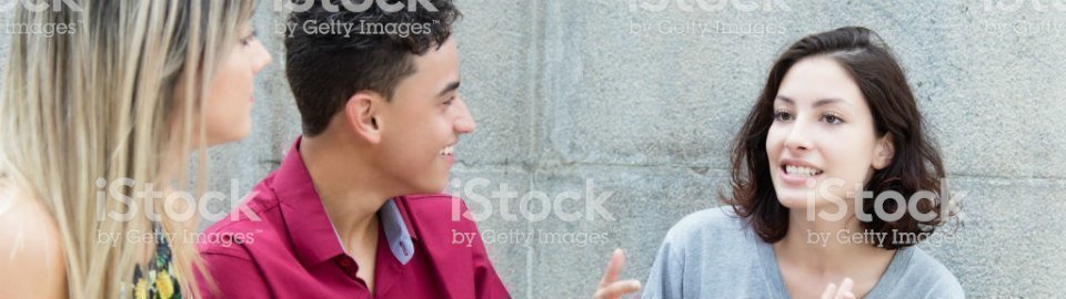 Three caucasian young adults in discussion outdoors in the summer