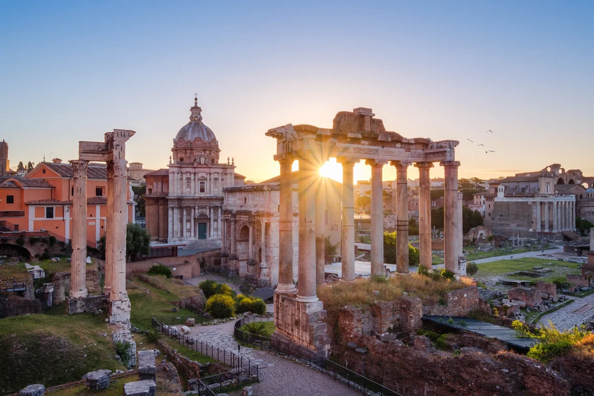 Roman Forum ruins glowing at sunrise, the world students step into through Familia Romana and Direct Method Latin