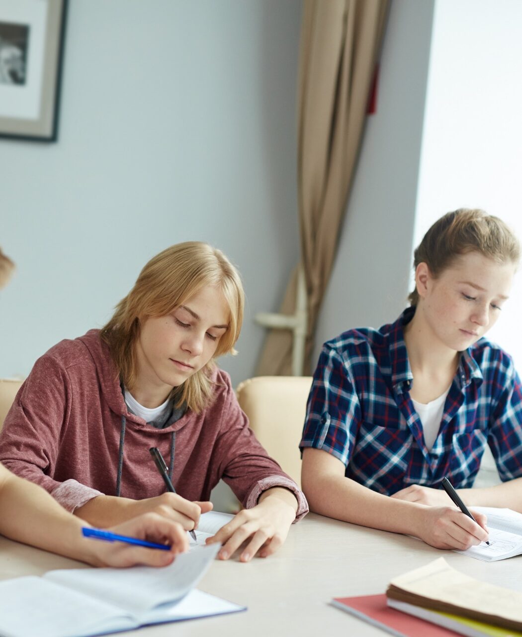 Two high school students studying together at a table